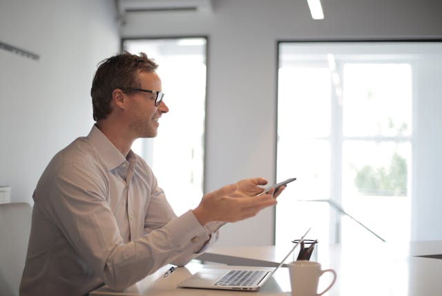 a property manager sitting at their desk on the phone