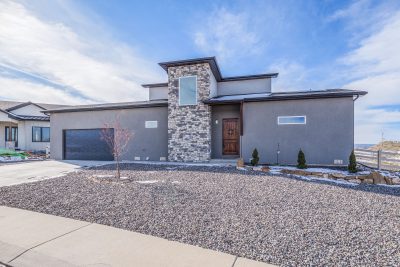Front exterior of a custom-built mountain home for sale in Montrose, Colorado with scenic surroundings