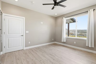 Bedroom with large windows and scenic San Juan Mountain views in a home for sale in Montrose, Colorado