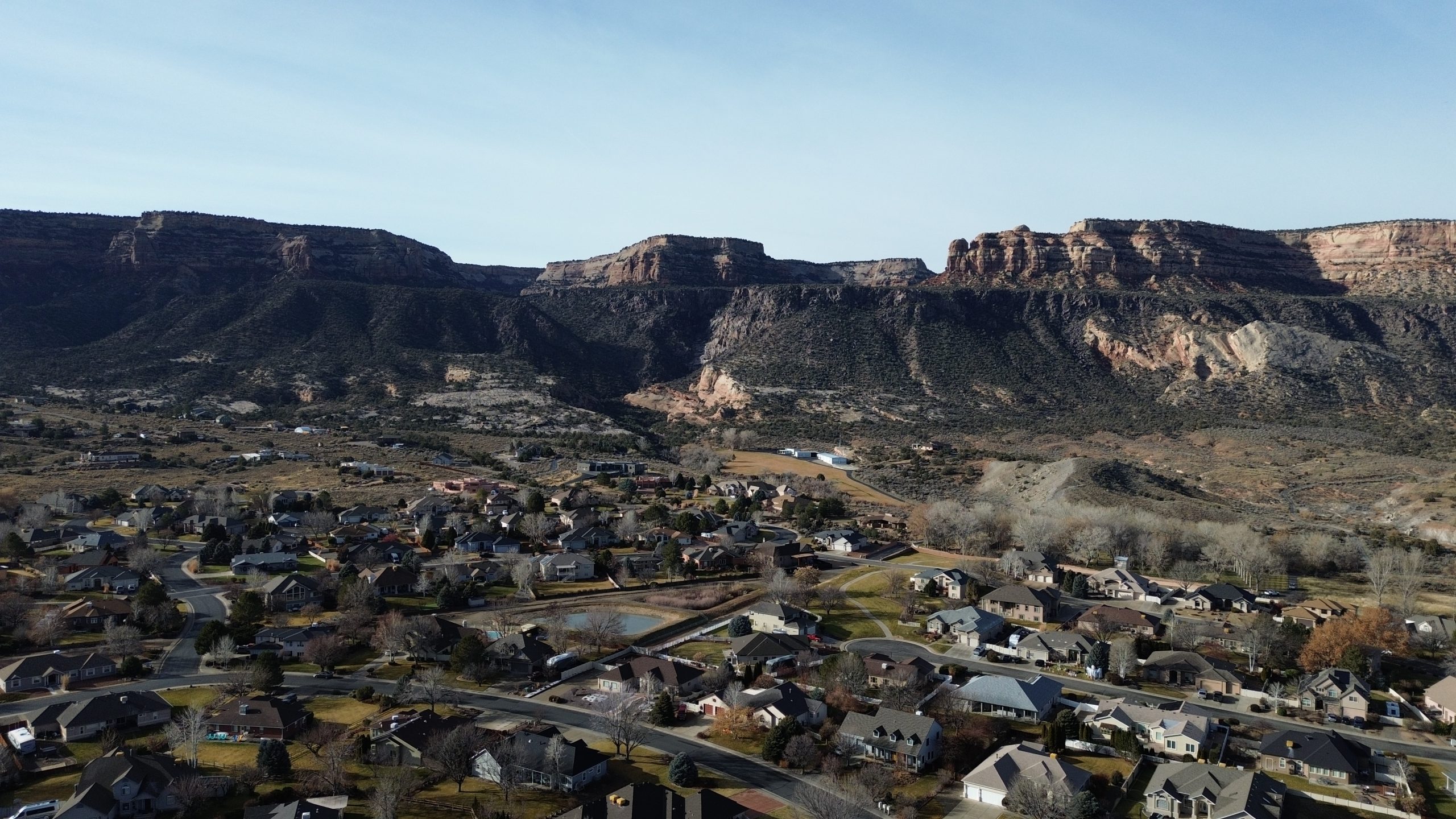 Aerial view of Canyon Rim subdivision in the Redlands area of Grand Junction, Colorado, with Colorado National Monument and nearby hiking trails